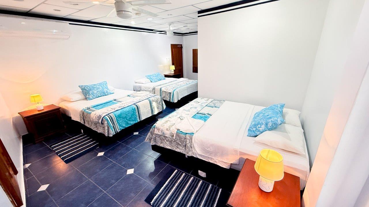Deep Blue Bedroom Casa Marina with three queen beds