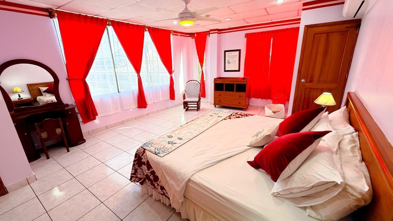 Red Master Bedroom Casa Marina Galapagos with king bed